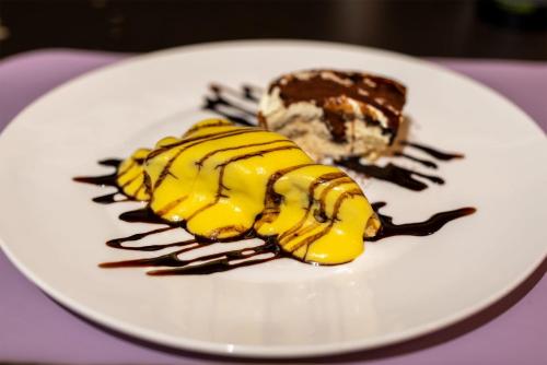 a white plate with a piece of cake and ice cream at Albergo Ristorante Il Terziere in Trevi