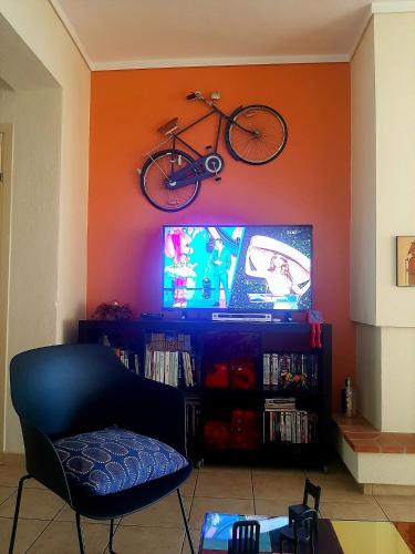 a living room with a bike hanging on the wall at Magic Mola in Mola Kalyva