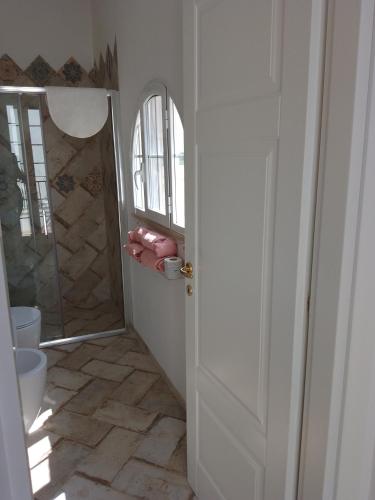 a bathroom door with a shower and a toilet at Casal Duca in Taranto