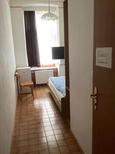 a small bedroom with a bed and a window at Hotel Pribitzer in Vienna