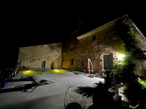 a large building with a courtyard at night at SCI Domaine Saint Martin le grand in Béziers
