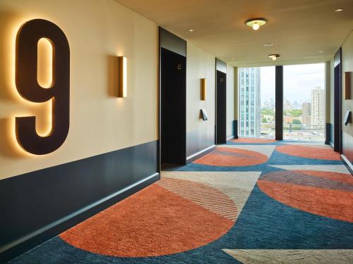 a hallway with a number on the wall at TRIBE London Canary Wharf in London