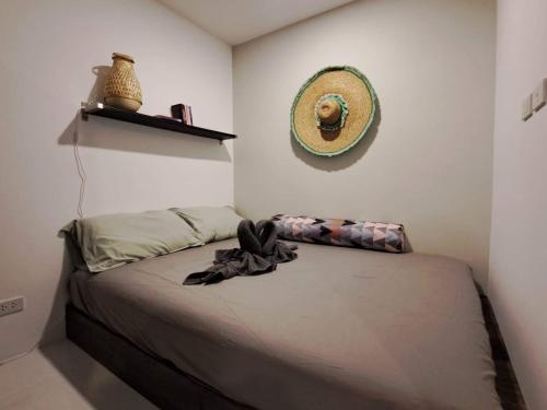 a bedroom with a bed with a hat on the wall at Mantra Holiday Home in Mae Pim