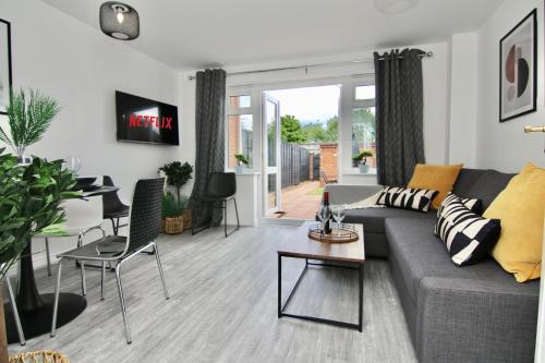a living room with a couch and a table at Dashing 2Bed Haven - Near Coventry Centre, Free Parking in Coventry