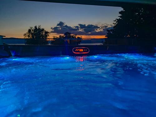 a swimming pool with blue lights in a backyard at Lago Hotel in Ohrid