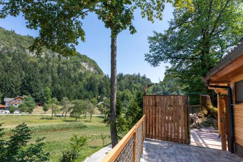 a view from the porch of a house with a wooden fence at Lavender Lodge Bled in Bled