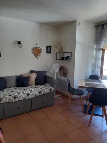 une chambre avec un lit, une table et des chaises dans l'établissement Studio cocooning centre historique d Avignon, à Avignon