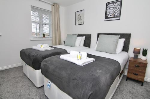 a bedroom with two beds and a window at Dashing 2Bed Haven - Near Coventry Centre, Free Parking in Coventry