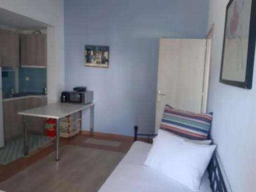 a living room with a white couch and a table at Palio Villa in Paleo Tsifliki