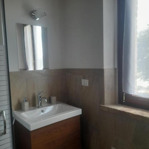 a bathroom with a sink and a mirror at Casale della rosa in Loreto
