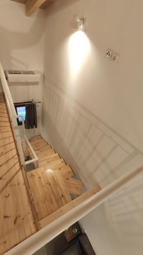 a staircase in a room with a wooden floor at Petrina Bolosis in Palaiókastron