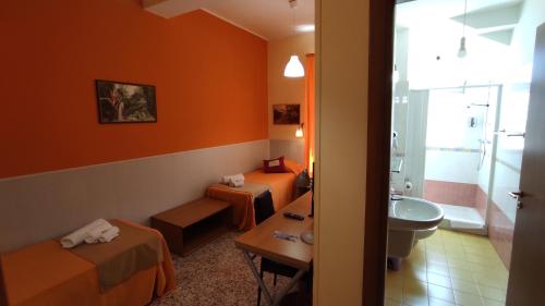 a hotel room with two beds and a bathroom at Abacus in Reggio di Calabria