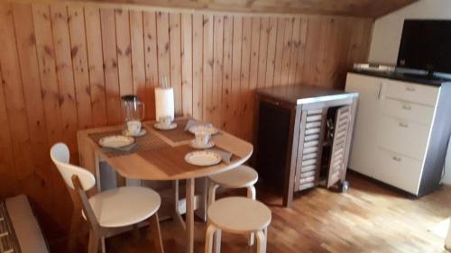 a kitchen with a wooden table and chairs and a small table and chairsktop at Apartments by the sea Cove Vela Stiniva, Hvar - 19951 in Zastražišće