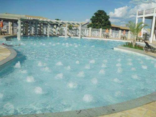 a large pool of blue water in a resort at Caldas Novas Lacqua Di Roma IV - 2 banheiros e cozinha, piscina 24 horas in Caldas Novas