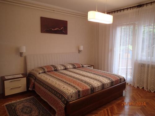 a bedroom with a bed and a large window at Guest house Marcel in Lovran