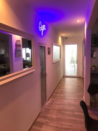 a room with a neon sign on the wall at ViNALUX in Vinaròs