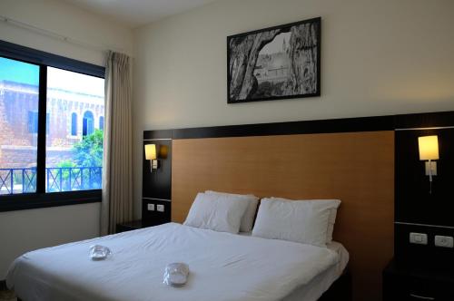 Postel nebo postele na pokoji v ubytování New Capitol Hotel - Jerusalem