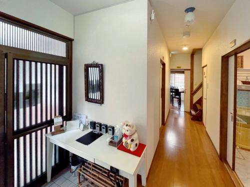 a living room with a sink and a hallway at KIX House 和楽二号館 in Izumi-Sano