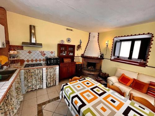 a room with a kitchen and a living room with a bed at La Villetta in Cansano