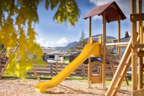 a playground with a yellow slide and a gazebo at Der Postwirt in Söll