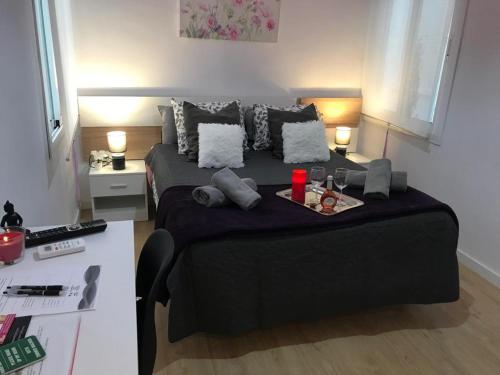 a bedroom with a bed with a tray of food on it at ViNALUX in Vinaròs