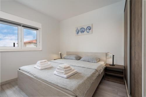 Postel nebo postele na pokoji v ubytování Apartmani Villa Ruby