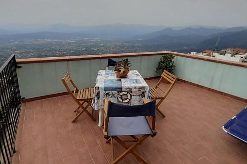 a table and chairs on a balcony with a view at Sa Mannalissa casa vacanza in Baunei