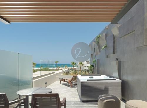 a dining room with a view of the beach at Nautilux Rethymno by Mage Hotels in Rethymno Town