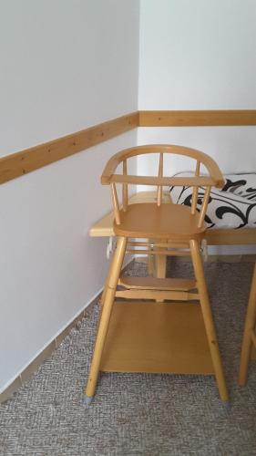 a small wooden chair sitting next to a table at APARTMÁNY - Pacholik in Rokytnice nad Jizerou