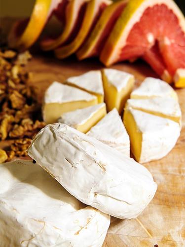 a group of cheese and fruit on a cutting board at The Sephardic House Hotel in The Jewish Quarter in Jerusalem