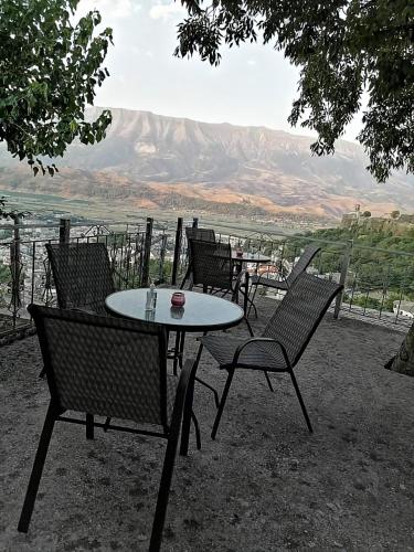 a table and chairs with a view of a mountain at Panoramic Vlachos in Gjirokastër