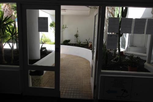an open door to a room with potted plants at Everything You Need. All Right Here. in Adeje