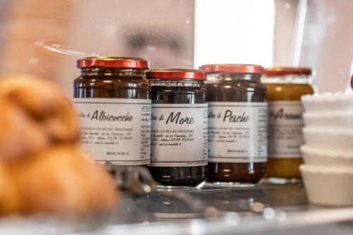 a group of jars of honey sitting on a shelf at Hotel More di Cuna in Monteroni dʼArbia