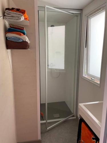 une salle de bain avec un miroir et un lavabo dans l'établissement Mobil home Argelès sur mer, à Plage dʼArgelès