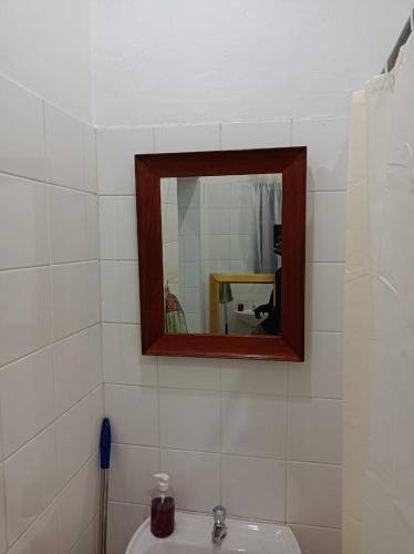 a bathroom with a mirror and a sink at Danodeb Lodge in Pietermaritzburg