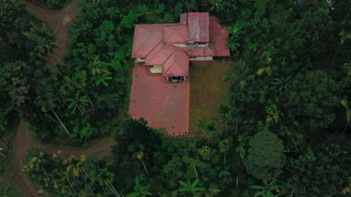 an aerial view of a house in the middle of a forest at Nandanam Villa in Kaniyāmbetta