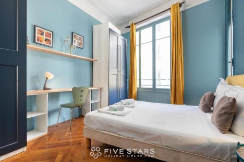 a bedroom with blue walls and a bed and a desk at Suite A Lorraine FSHH in Nice