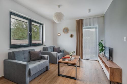 a living room with a couch and a table at Siedlisko Szlachtowskie in Szczawnica