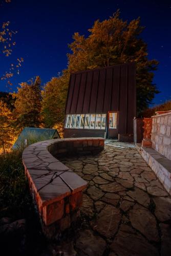 a stone walkway leading to a building at night at Stairway - Vučje in Nikšić