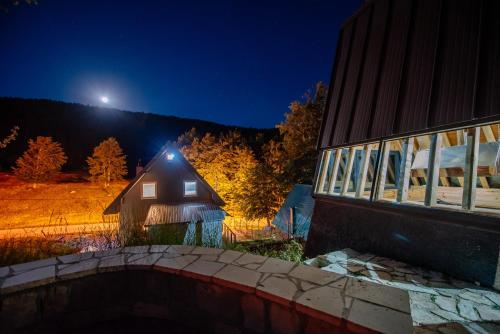 a house with a light on the side of it at night at Stairway - Vučje in Nikšić