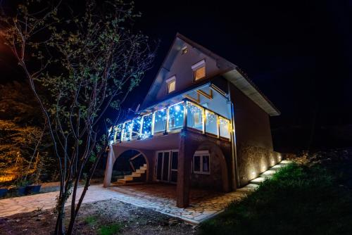 a house with lights on it at night at Stairway - Vučje in Nikšić