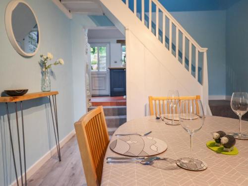 a dining room with a table with wine glasses at Preswylfa in Blaenau-Ffestiniog