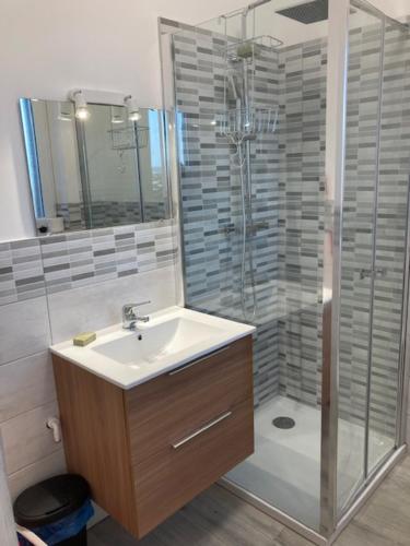 a bathroom with a sink and a shower at Casa dei Gelsomini in Trieste
