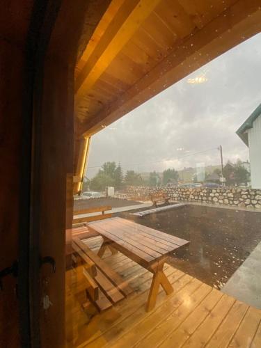 a picnic table on the deck of a building at DANDELION HOUSE in Žabljak