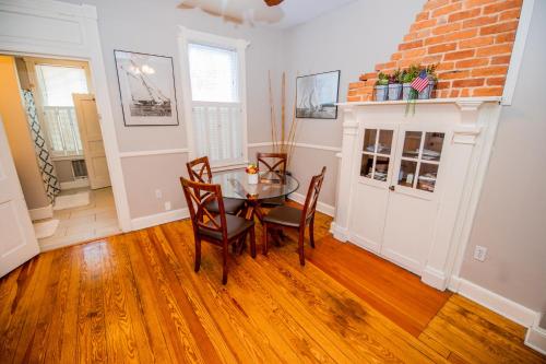 a dining room with a glass table and chairs at Downtown Annapolis King George 1st Floor Hideaway in Annapolis