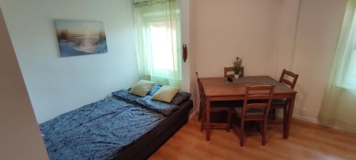a bedroom with a bed and a dining room table at Studio / Apartament Sopot zentrum in Sopot