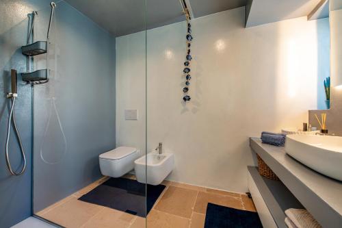 a bathroom with a shower and a toilet and a sink at Belvedere Apartment & Pool - Housea in Polignano a Mare