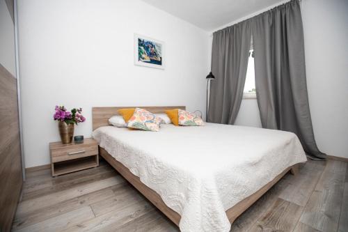 a bedroom with a bed and a window at Villa Marleku in Pakoštane