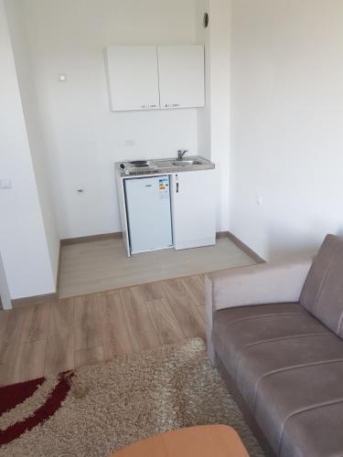 a living room with a couch and a kitchen at Dina & Dona in Ulcinj