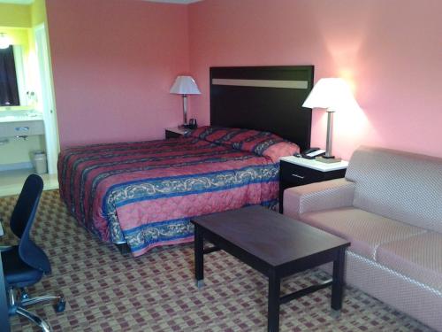 a hotel room with a bed and a couch at Elkton Lodge in Elkton